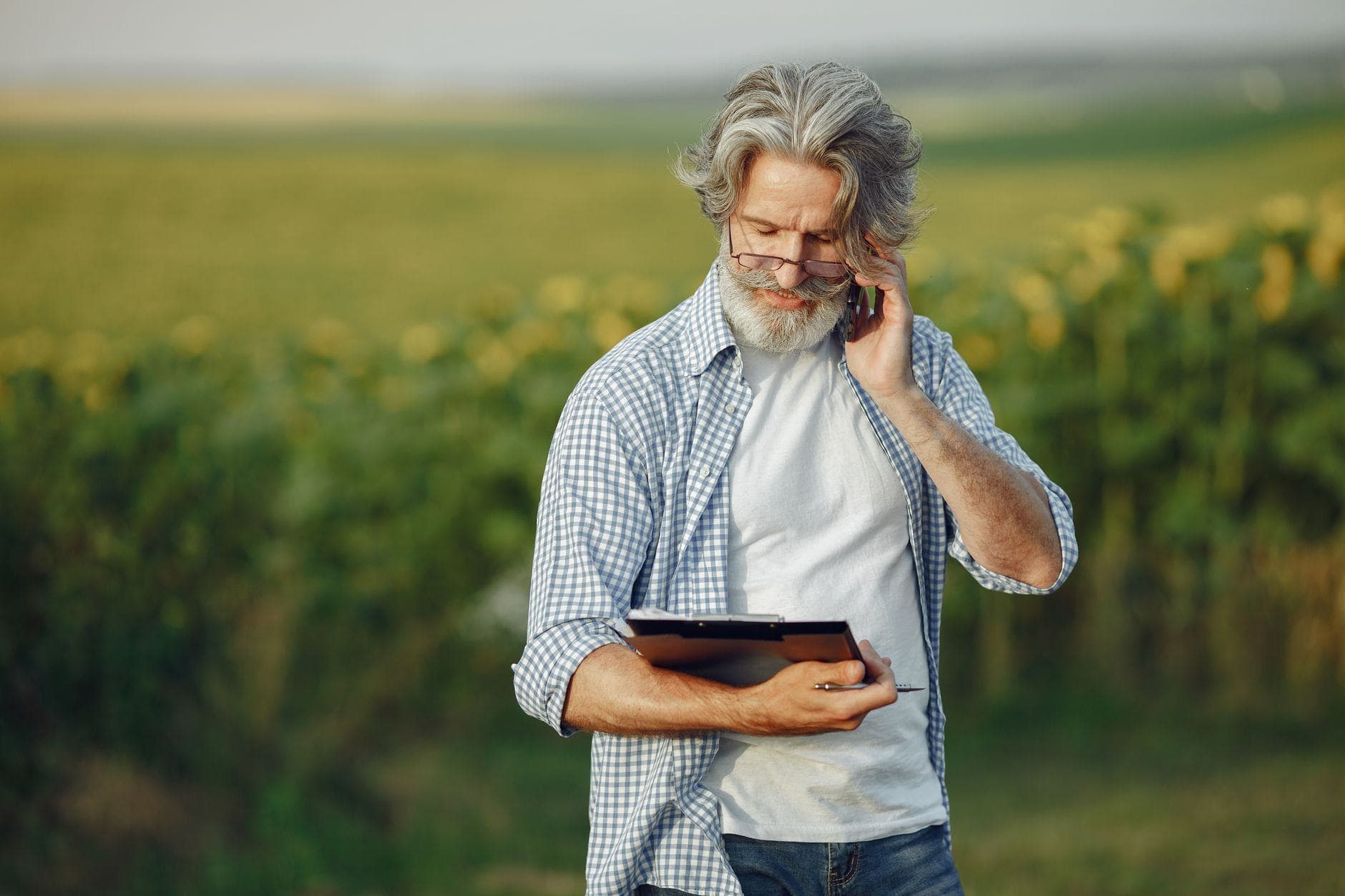 Farmer on a phone holding a clipboard