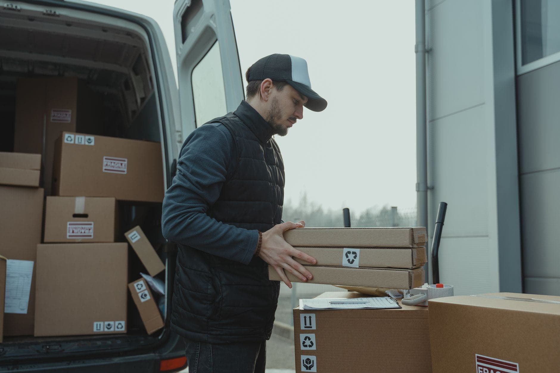 Worker loading boxes into a van